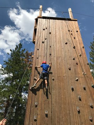 Camper climbing the climbing wall at Camp Nawakwa