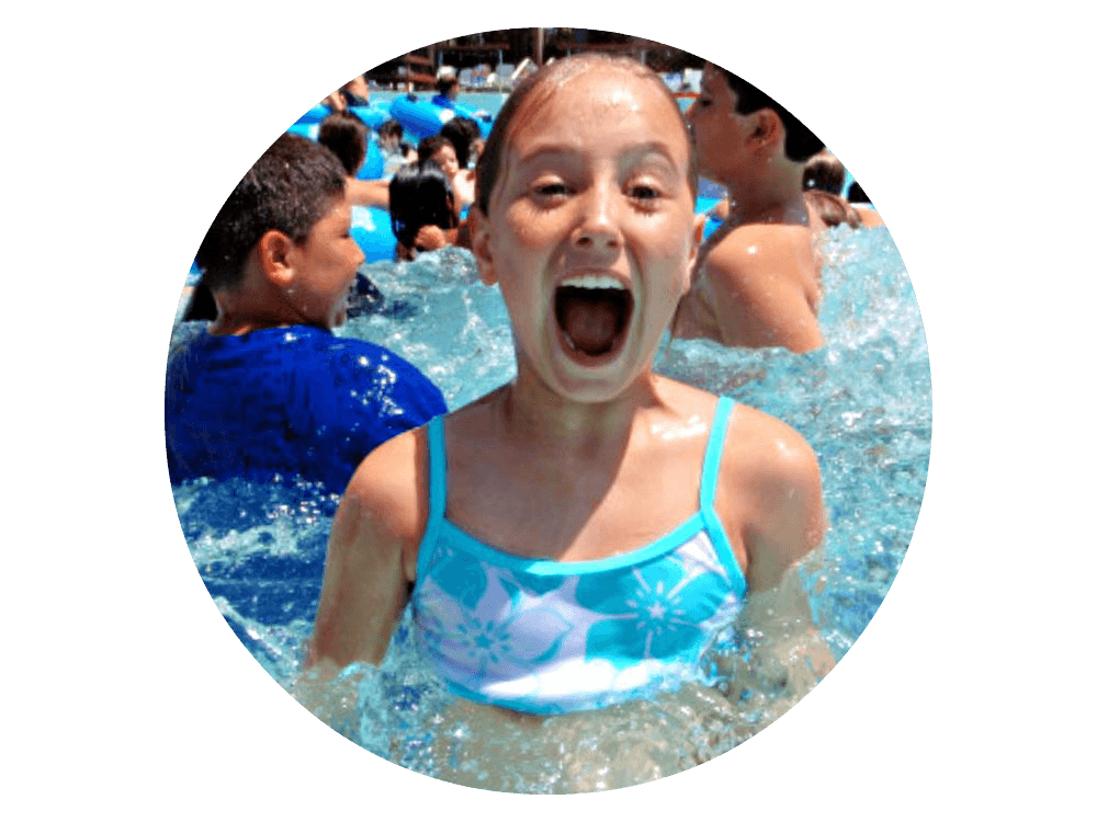 Girl popping her head out of the swimming pool at camp