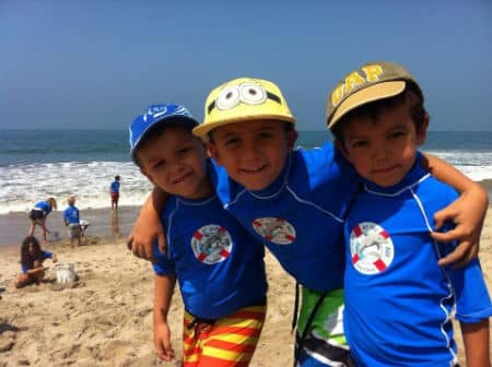 Three boys from Hancock Park with arms around each other at Fitness by the Sea Day Camp