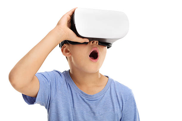 Boy looking through his virtual reality goggles at summer camp