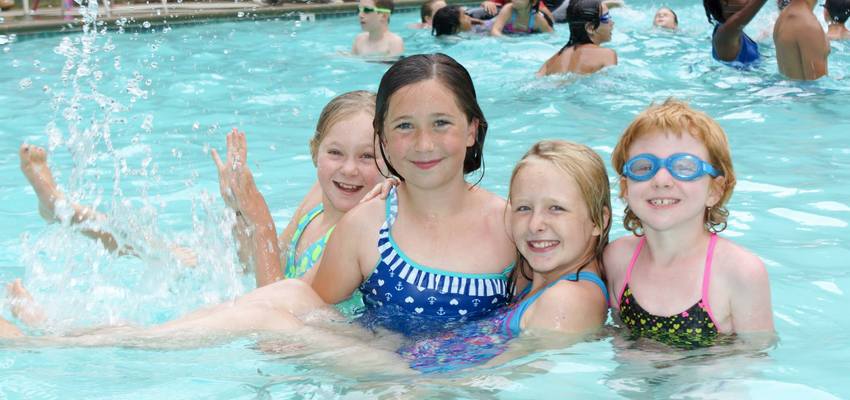 Four female campers in the swimming pool at Camp Quest West Summer Camp