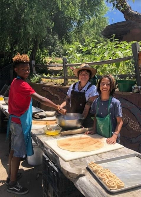 Campers doing and staff enjoying a cooking activity at Camp Stevens