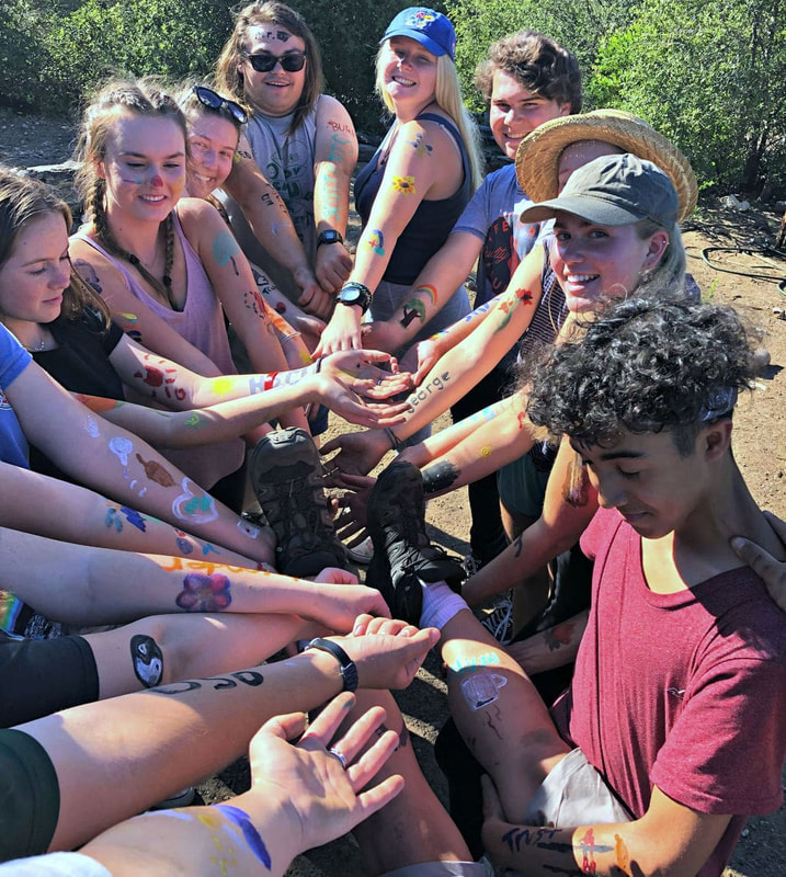Group of campers showing off their face paint, body paint and temporary tattoos they got at Camp Stevens.