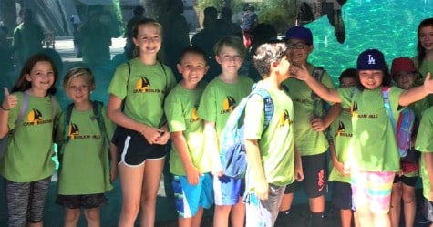 Group of kids from Camp Woodland Hills on a field trip at the aquarium.