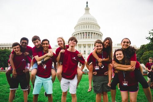 10 Capitol Debate summer camp participants, all teenagers, pose for a group photo in front of the Nation's Capitol in Washington, DC