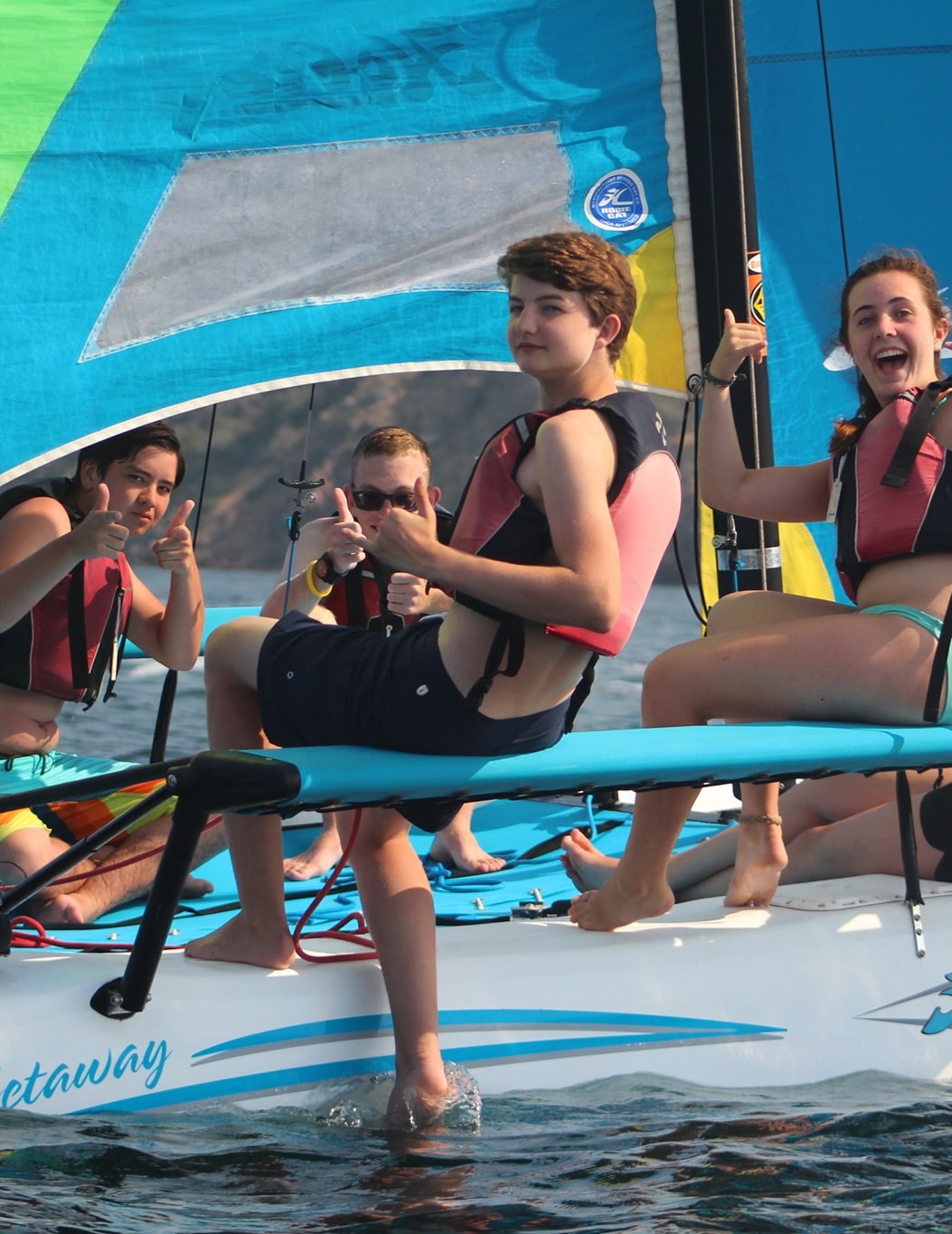 Teenage campers riding a catamaran in the ocean at Catalina Sea Camp
