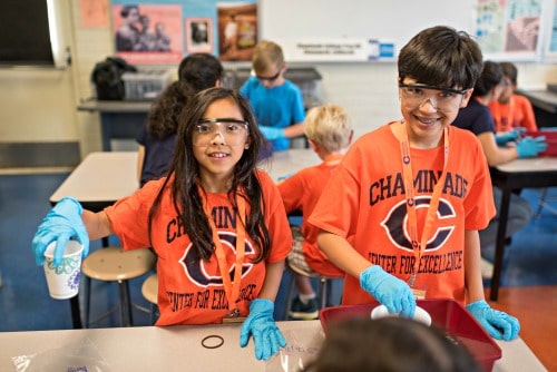 Boy and girl campers doing a science project together at Chaminade Center for Excellence's summer camp program.
