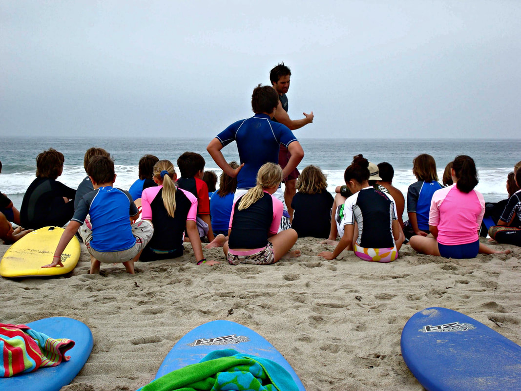 Surf camp counselor and instructor Cory Bluemling reviews beach, surf and ocean safety with campers on the beach at Aloha Beach Camp Summer Day Camp.Picture