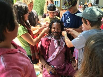 Campers dressing up their Camp Counselor in costumes and jewlry at Crystal Camp in Santa Monica.