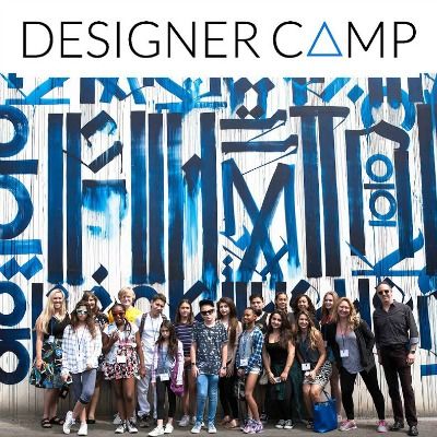 Campers and staff standing as a group in front of huge desinger summer camp logo painted in blue against a white wall beind them.