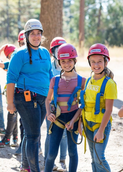 Female campers and their counselor preparing to enjoy the High Ropes course activity at AstroCamp overnight summer camp