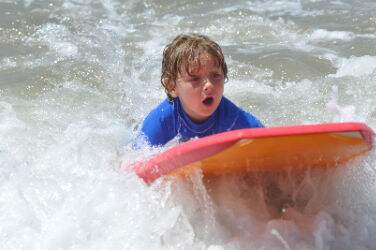 Boy from Culver City boogie boarding at Fitness by the Sea Beach Camp