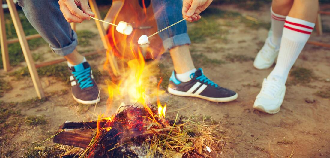 Campers roasting marshmallows at summer camp in los angeles