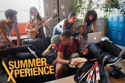 Five student participants at Los Angeles College of Music sitting together on a couch and playing various musical instruments together.