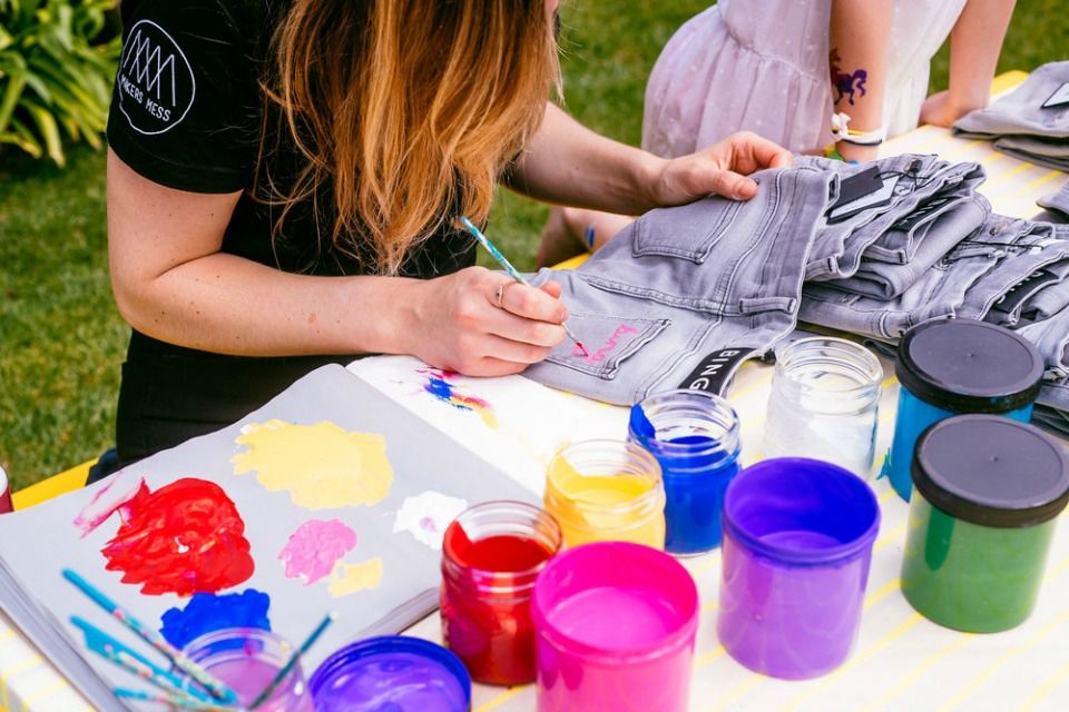 Girl painting her pants at Makers Mess Summer Camp