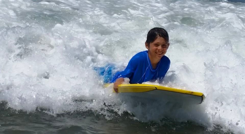 Boy boogie boarding at Fitness by the Sea summer camp