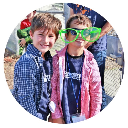 Two boys at summer camp wearing their PlanetBravo Techno-Tainment Summer Camp