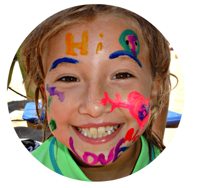 Young girl from the San Fernando Valley with her face painted enjoying summer camp.