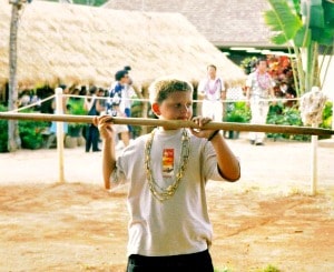 12-year old boy particpating in a spear-throwing game at Aloha Beach Camp's Hawaii summer camp program.