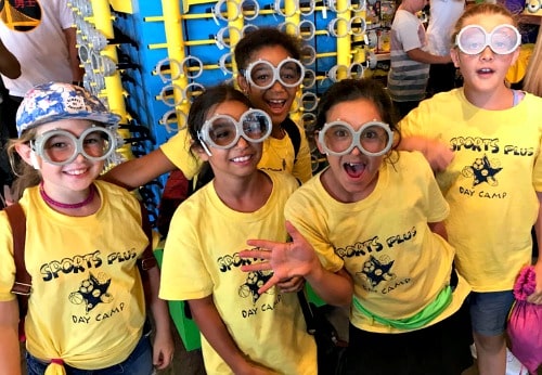 Five girls wearing huge bubble-eye funny glasses at Sports Plus Day Camp