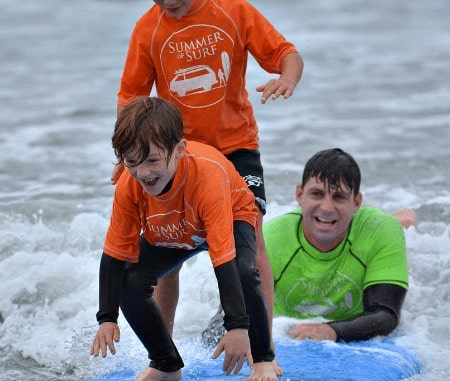 Boy learning to surf at Summer of Surf Camp