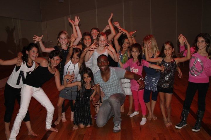 Kids and owner of Time 2 Dance Keith-Alan in a group photo on the dance floor.