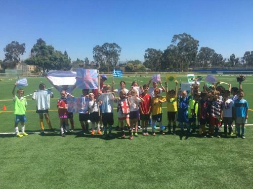 20 campers at UK International Soccer Camps in Los Angeles standing on a soccer field together