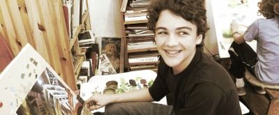 Teenage boy painting at Wizard of Art Summer Camp
